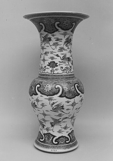 Vase decorated with cranes amid clouds