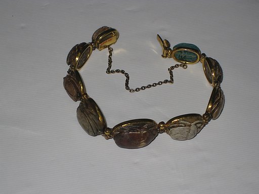 Nine scarabs set in modern bracelet.