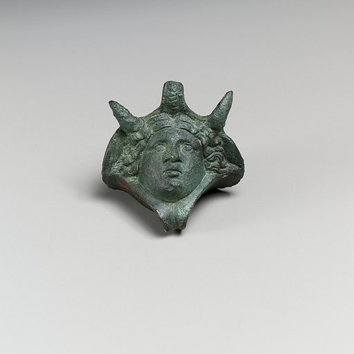 Decorative attachment in the form of a head wearing an elephant headdress