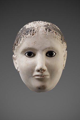 Mask of a woman with her hair rolled back at the forehead and temples