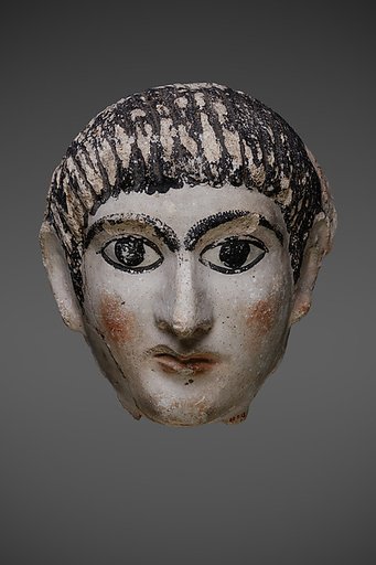 Mask of a man with hair combed forward and a mantle