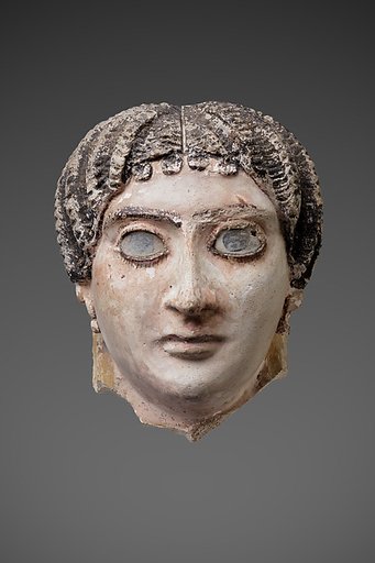 Mask of a woman with radiating waves of hair