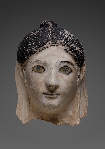 Mask of a woman with her hair in a small knot