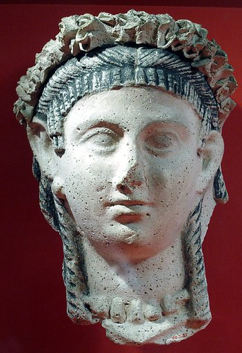 Mask of a woman with ball earrings, corkscrew locks and bang