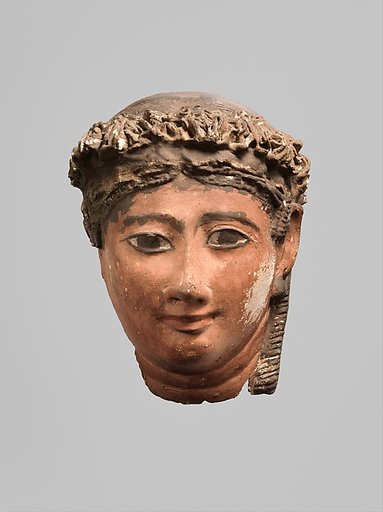 Mask of a woman with corkscrew locks and ball earrings