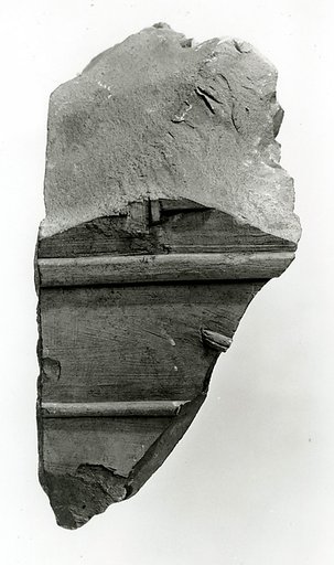 Raised relief fragment with remains of hieroglyphs