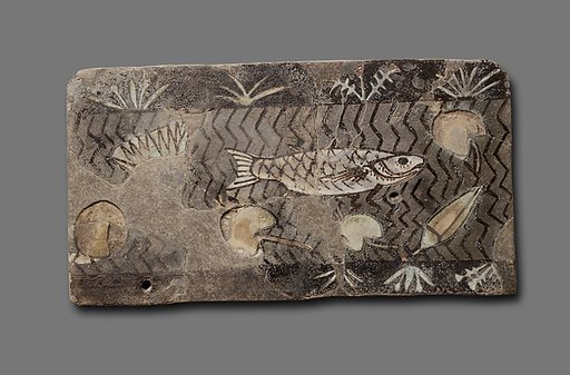 Tile with fish and lotus flowers in a canal