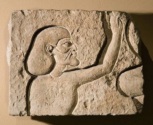 Relief fragment of an Asiatic raising his hands in adoration
