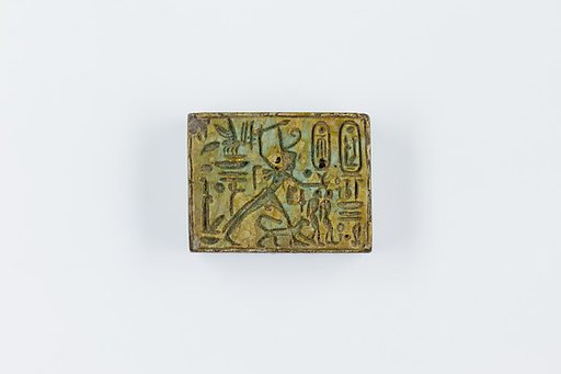 Oblong Plaque Depicting Ramesses II Smiting Enemies, opposite side relief scene of Isis and Nephthys flanking falcon labeled Horus son of Isis