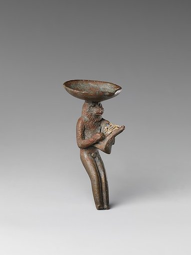 Monkey playing the lyre and carrying a dish on its head