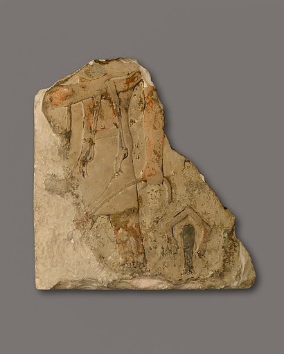 Relief fragment of a man carrying an ostrich