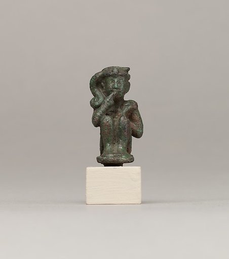 Crouching child god holding scepter
