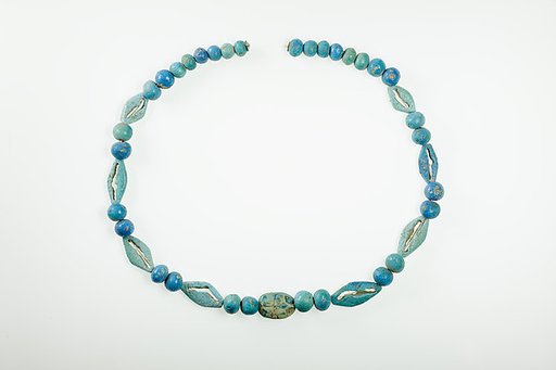 String of  ball beads, cowrie-styled beads, and a scarab