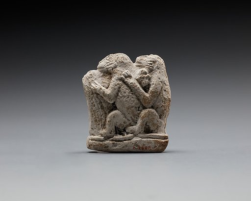 Monkey couple, the first playing a harp?