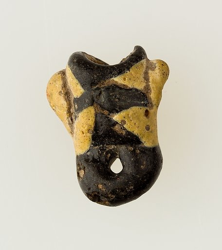 Amulet in form of human face