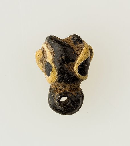 Amulet in form of human face