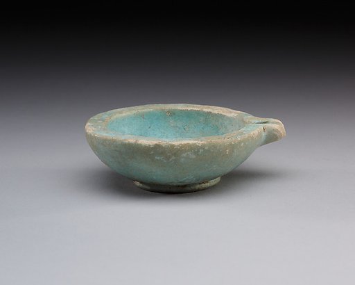 Spouted dish with rosette in the center, traces on the rim where two lions were attached