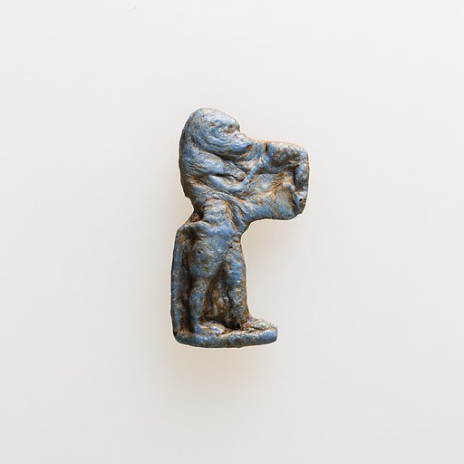 Amulet of a baboon holding an unrecognizable object