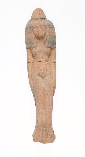 Standing female figurine wearing large headdress and wax cone