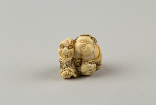 Netsuke of Okame Holding a Mask