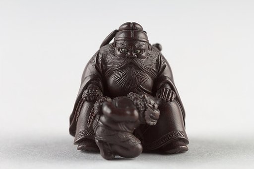 Netsuke of Man with a Demon on a Chain