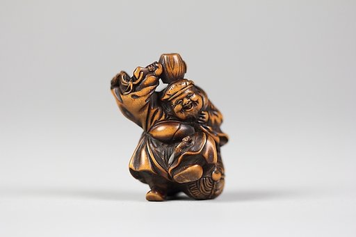 Netsuke of Daikoku and Mallet on Bale