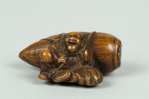 Netsuke of Old Man Carrying a Very Large Acorn