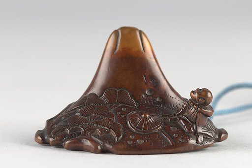 Netsuke in shape of Mount Fuji with Traveling Monk and Pine