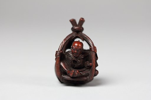 Netsuke of Old Man in a Basket