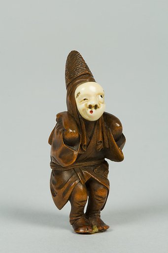 Netsuke of Boy Wearing an Ivory Mask