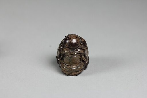 Netsuke of of a Priestling Asleep over a Stonemill