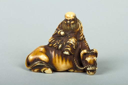 Netsuke of Man Sitting on a Recumbent Ox