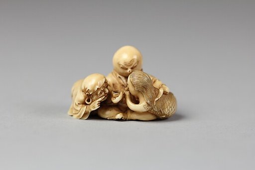 Netsuke of Daruma Admonishing a Mermaid Serving Sake to an Octopus
