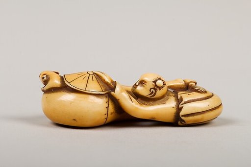 Netsuke of Boy Catching a Mouse in a Gourd