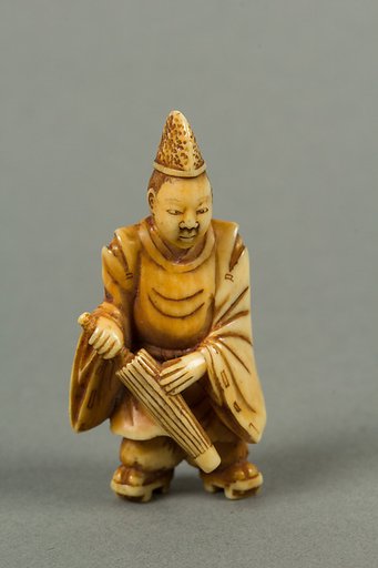 Netsuke of a Boy Carrying an Umbrella