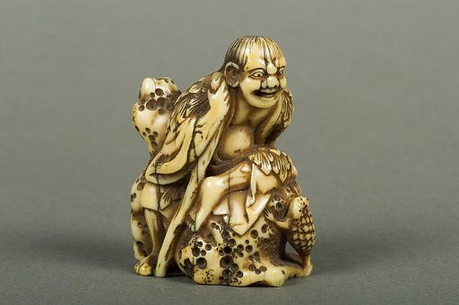 Netsuke of Old Man Sitting on a Rock