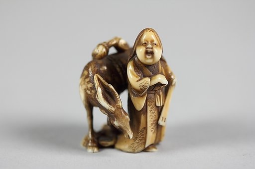 Netsuke of Female Figure (Okame) with a Deer