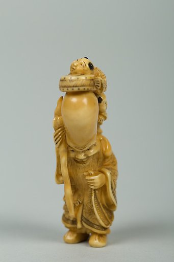 Netsuke of Fukurokujin with Tall Head and Two Children Climbing on It