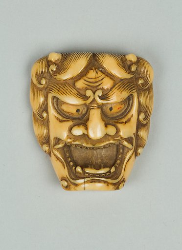 Netsuke of Mask of a Man with Open Mouth and Curly Hair