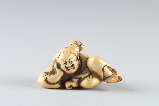 Netsuke of a Man Sleeping while Monkey Steals Contents of Basket