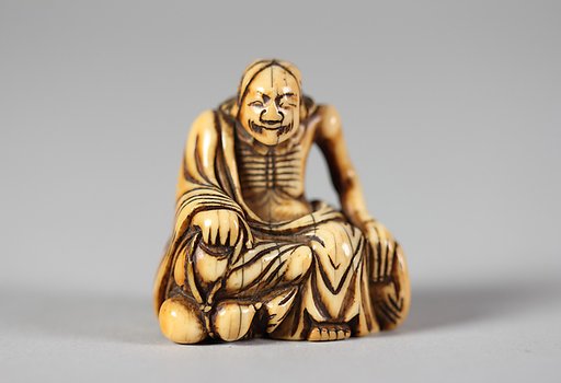 Netsuke of Old Man Seated on a Rock