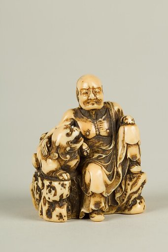 Netsuke of Man and a Qilin Sitting on a Rock