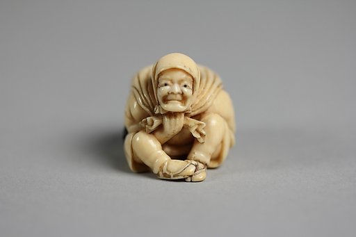Netsuke of Old Man Carrying a Bag of Ōni (Demons)