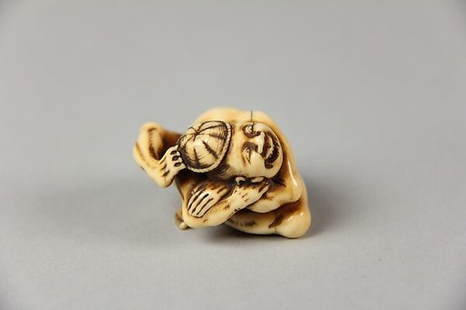 Netsuke of Acrobat Removing his Hat with His Foot