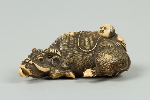 Netsuke of Boy Climbing over the Back of a Cow
