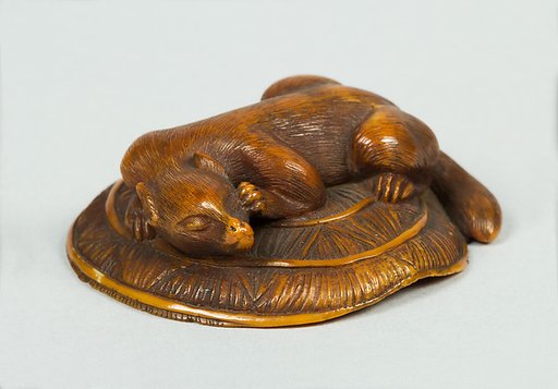 Netsuke of Animal on a Straw Mat under which is a Mouse