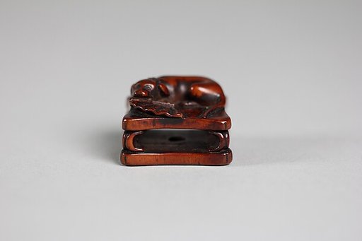 Netsuke of Dog and Fan on a Bench