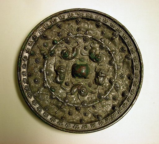 Mirror with fantastic animals amid grape vines