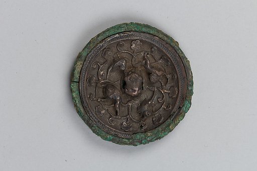 Mirror with birds and lions amid flowers