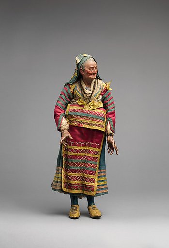 Old woman in blue dress and various color apron